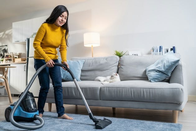 Woman vacuuming living room